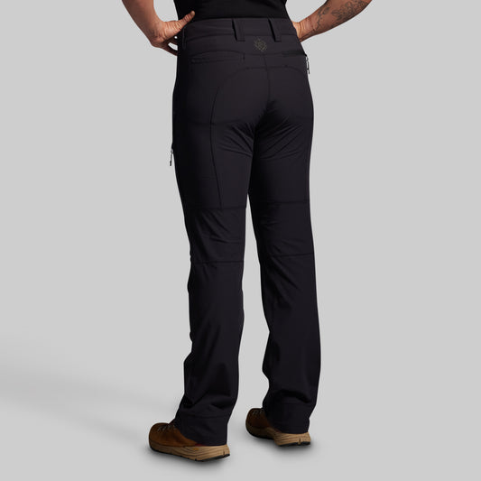 Black pants worn by a person on a gray background