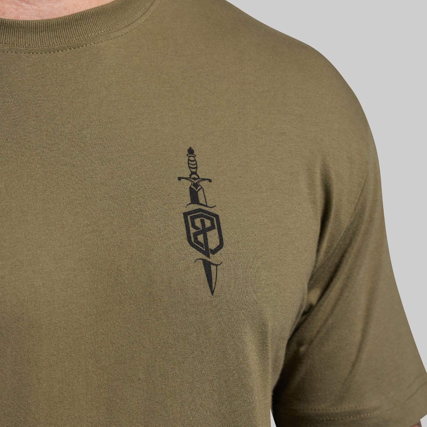 Olive green t-shirt with a black design on the chest against a light gray background