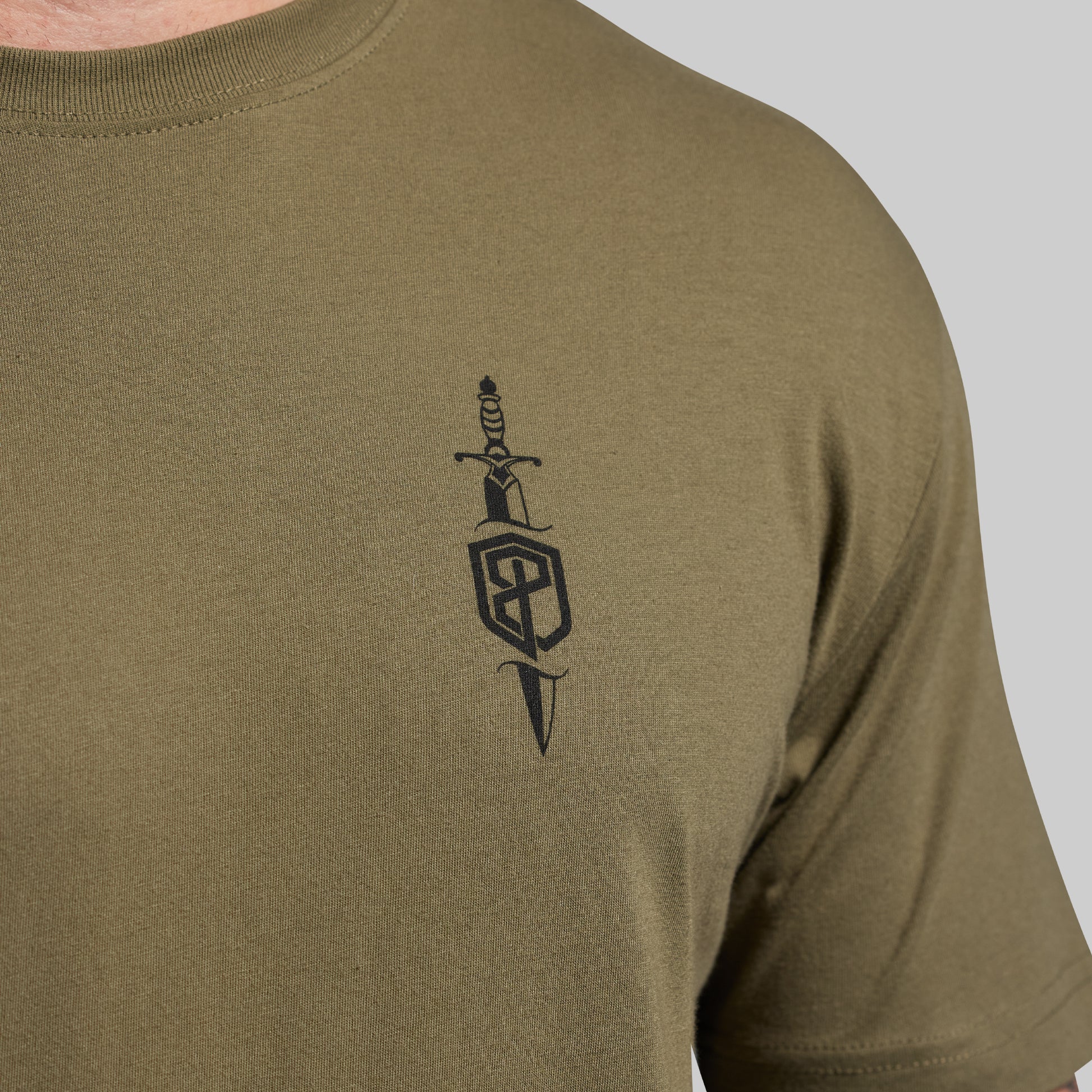 Olive green t-shirt with a black design on the chest against a light gray background