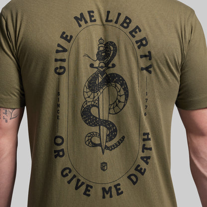 Green t-shirt with black snake and sword graphic and text on a plain background