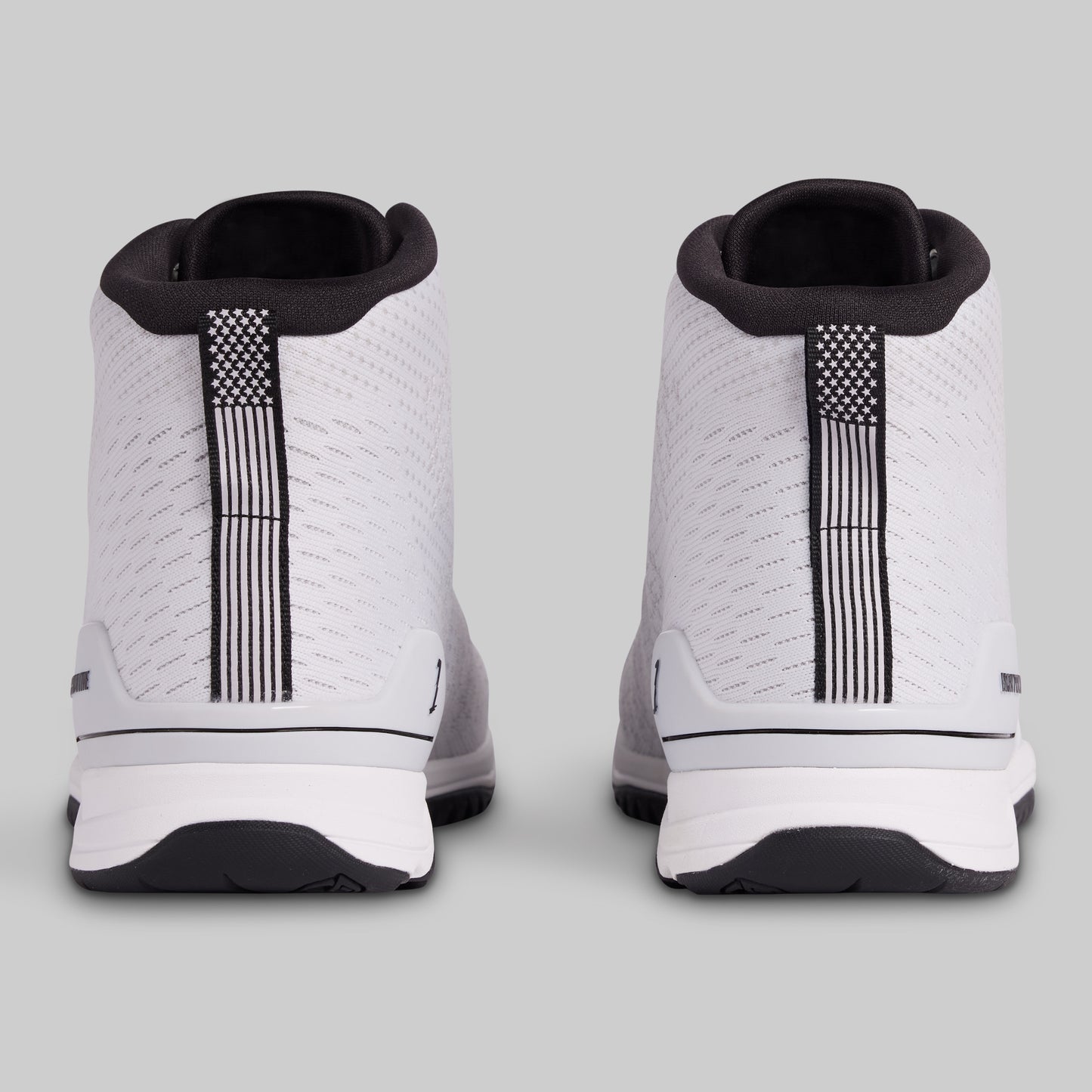 White sneakers with black accents on a light gray background