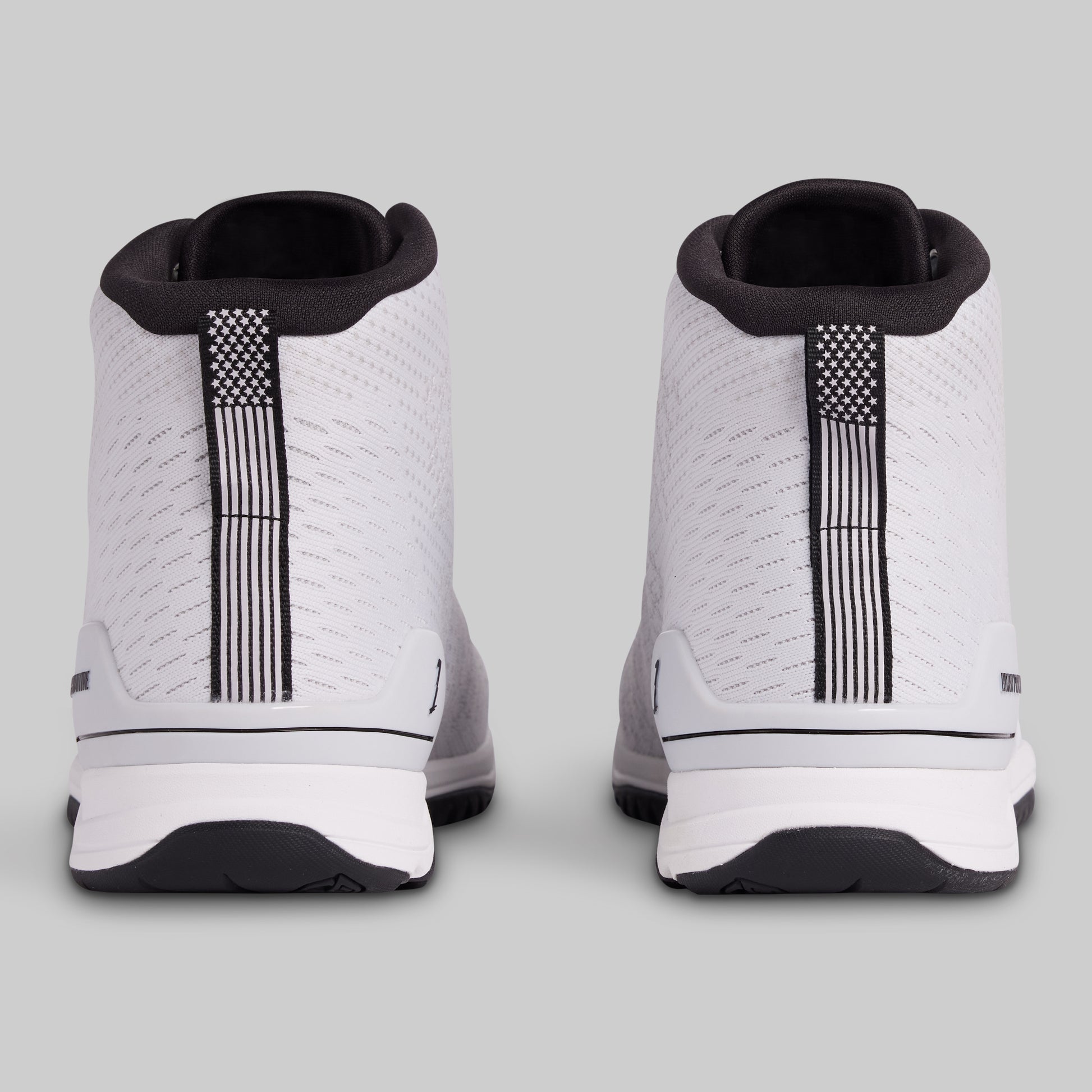 White sneakers with black accents on a light gray background