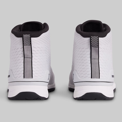 White sneakers with black accents on a light gray background