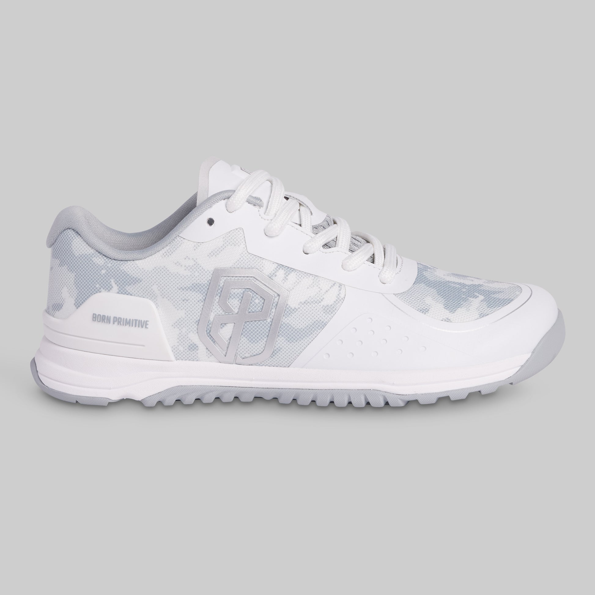 White athletic shoe with a patterned sole on a gray background