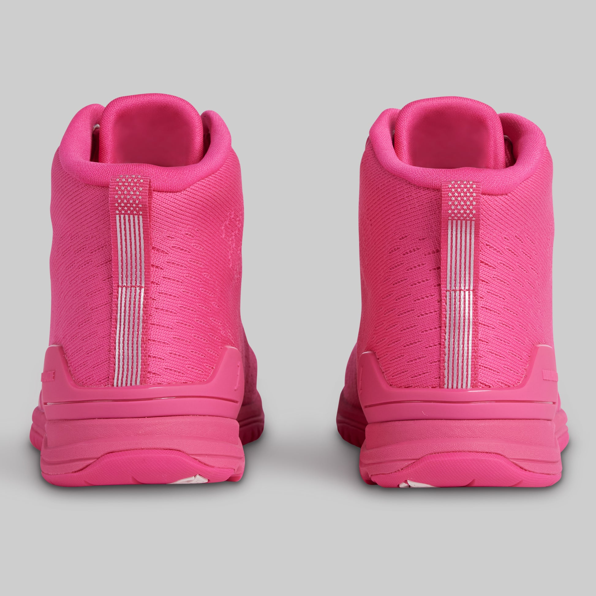 Pink high-top sneakers on a gray background