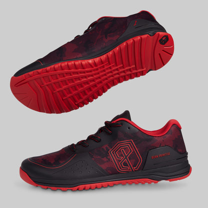 Black and red athletic shoes on a gray background