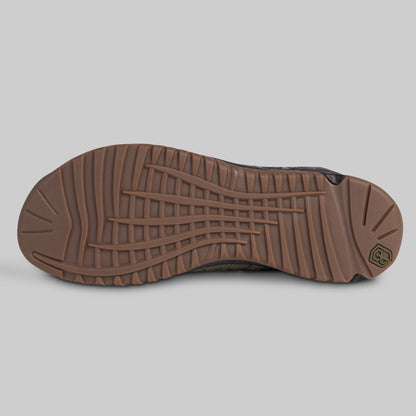 Brown shoe sole on a gray background