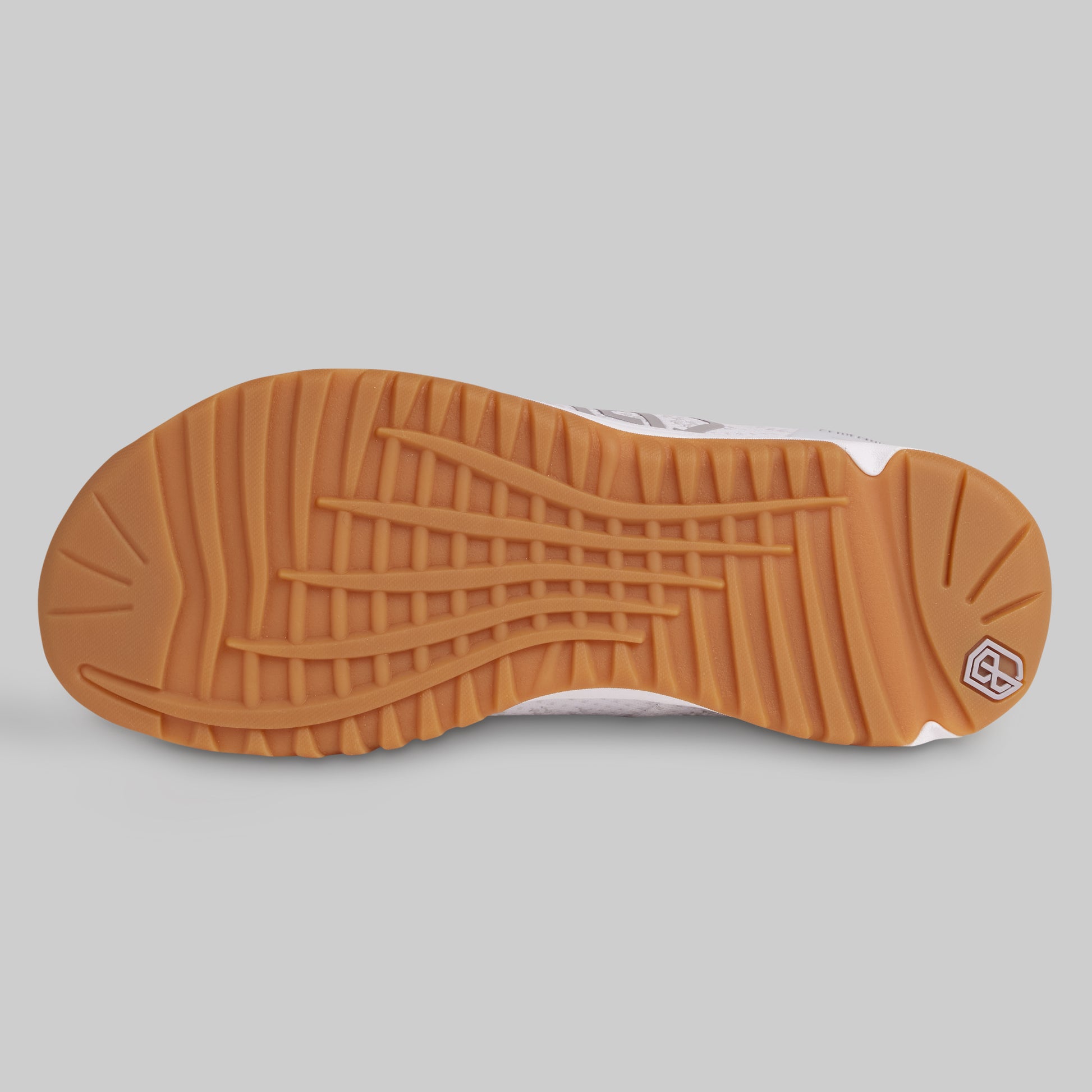 Close-up of a shoe sole with a textured pattern on a gray background