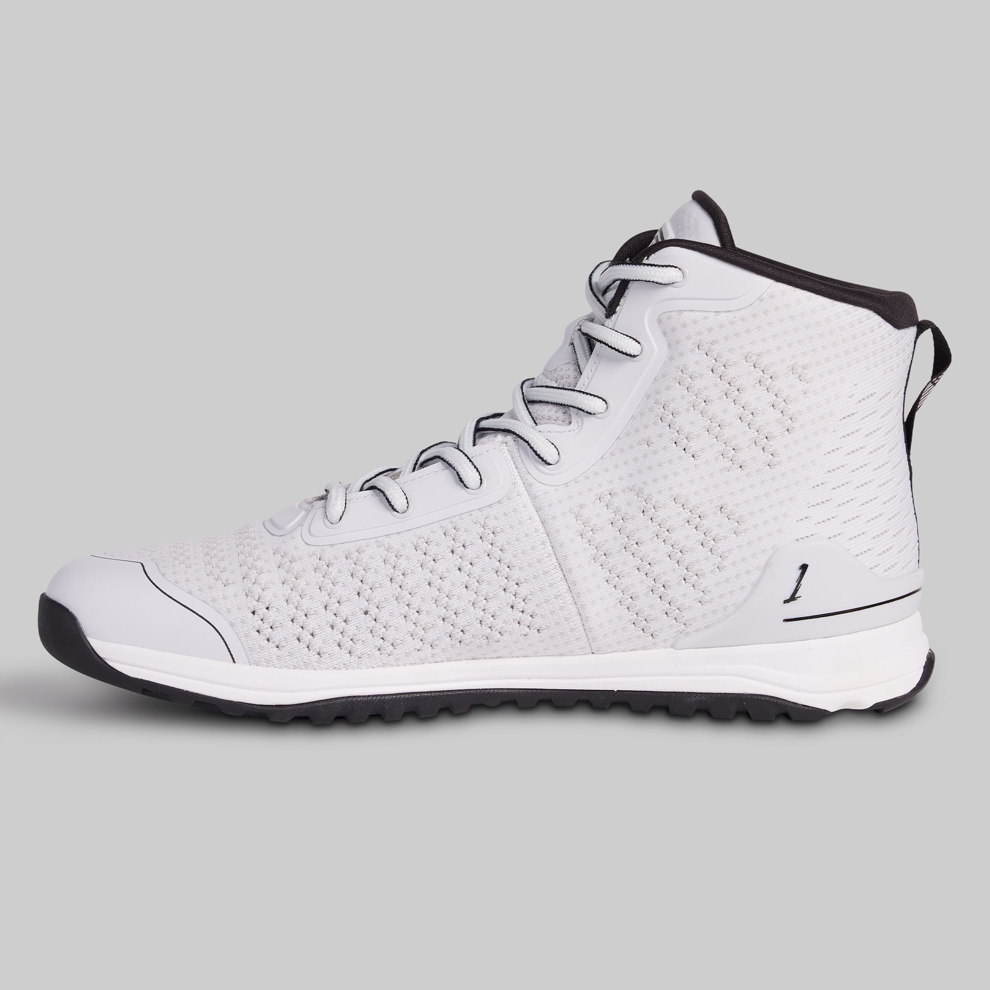 White high-top sneaker with black accents on a gray background