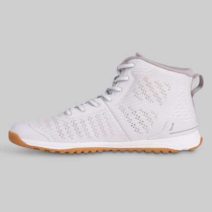 White sneaker with brown sole on a gray background