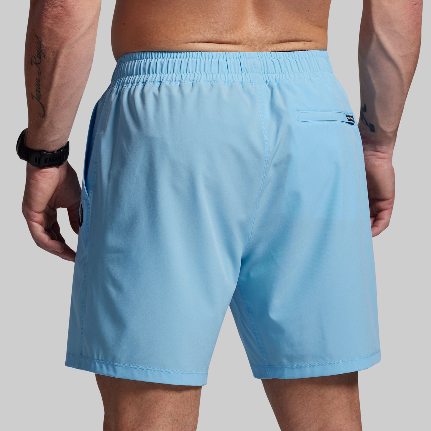 Light blue shorts worn by a person on a plain background