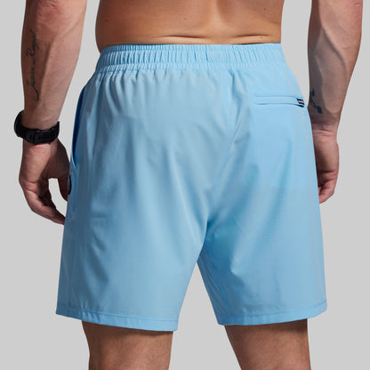 Light blue shorts worn by a person on a plain background