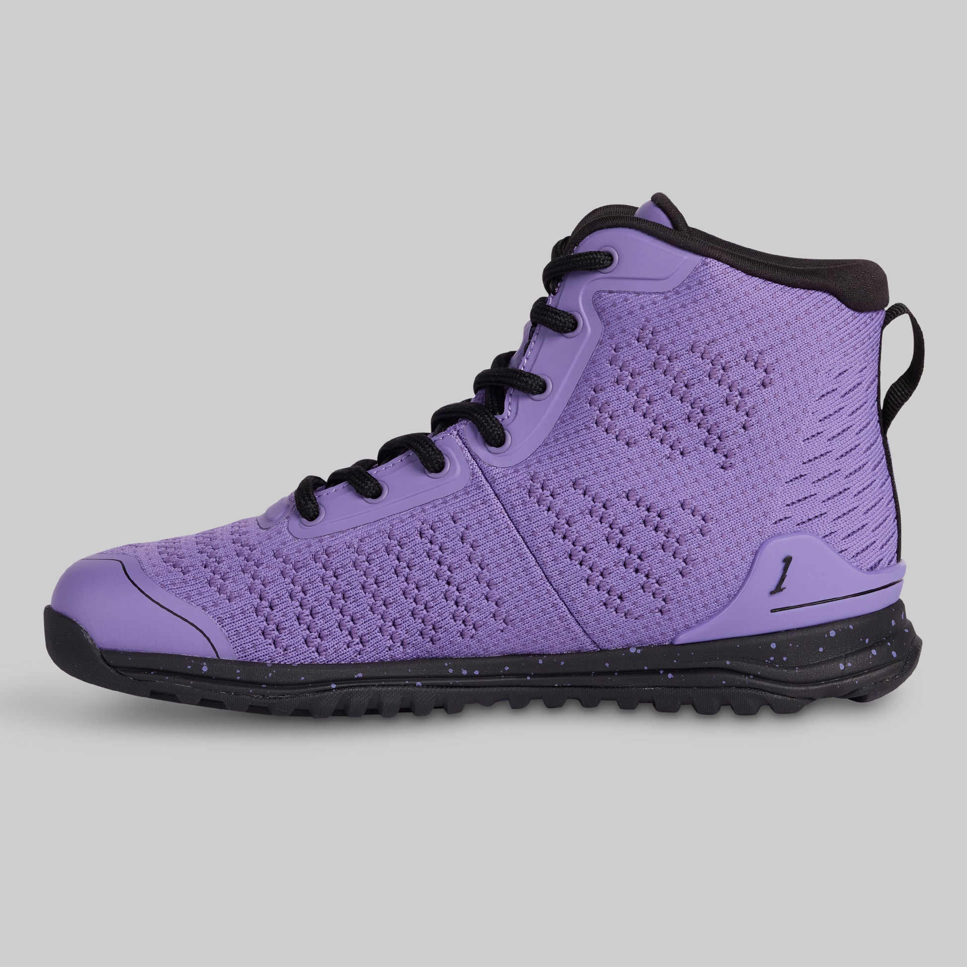 Purple sneaker with black laces and sole on a gray background