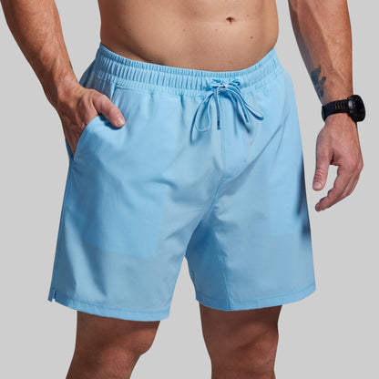 Light blue swim shorts worn by a person on a plain background