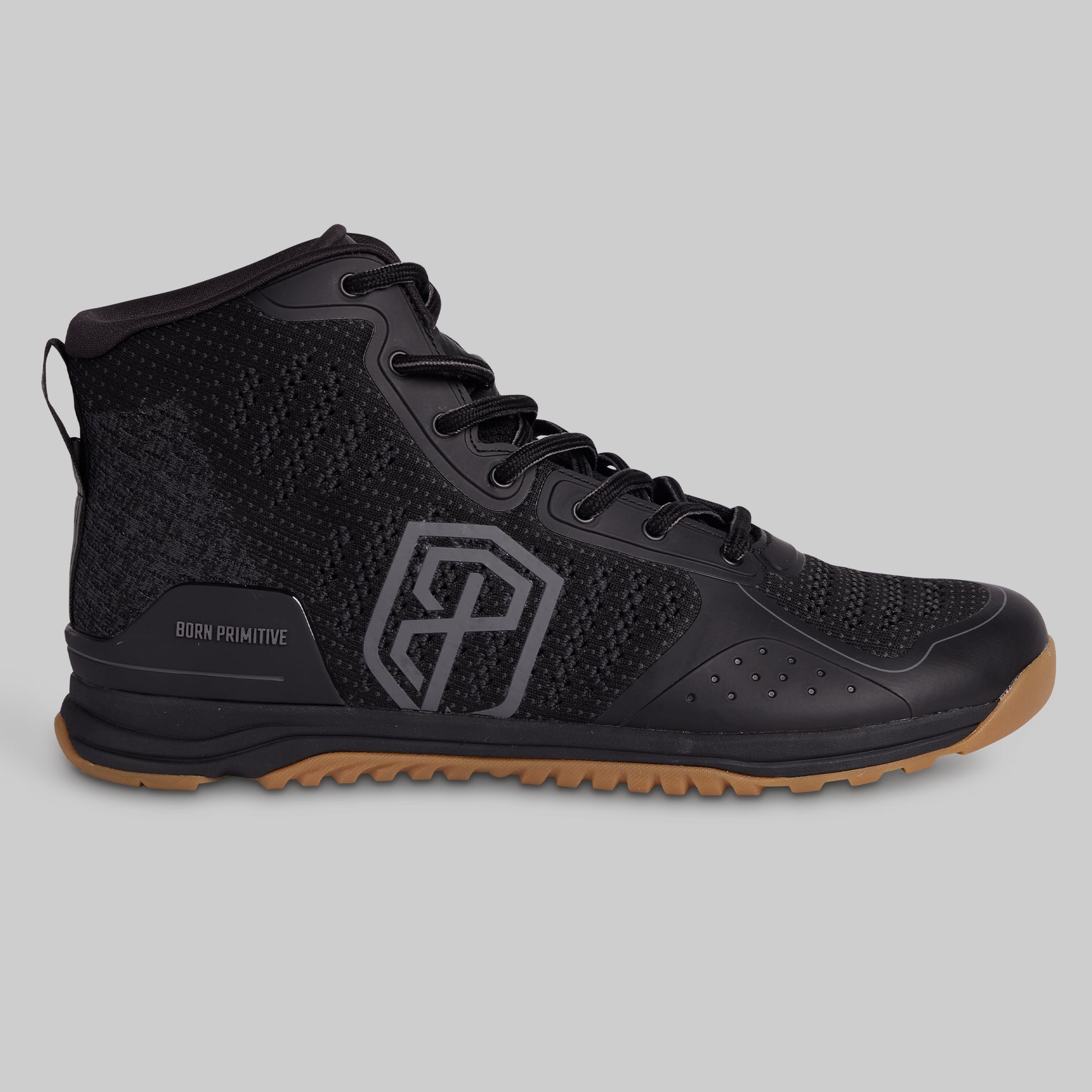 Black high-top sneaker with a brown sole on a gray background