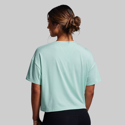 Person wearing a light blue t-shirt on a gray background