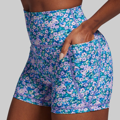 Floral patterned shorts worn by a person on a plain background