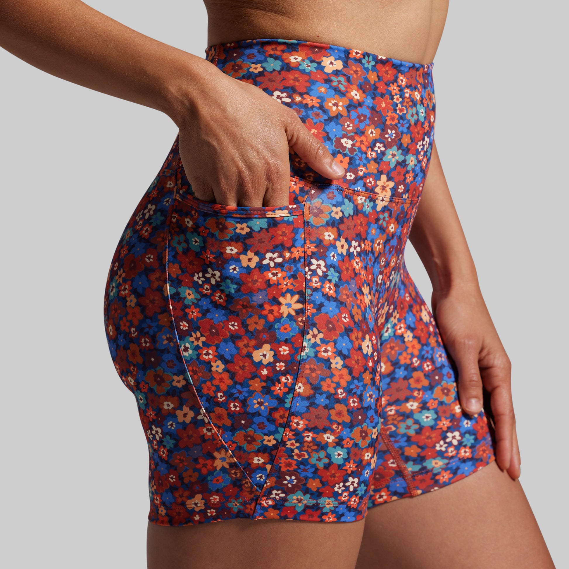 Floral patterned shorts worn by a person on a plain background