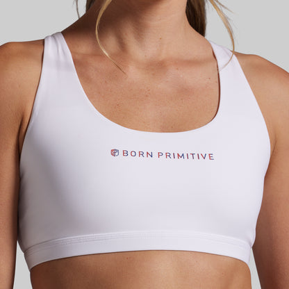 White sports bra with 'Born Primitive' logo on a neutral background