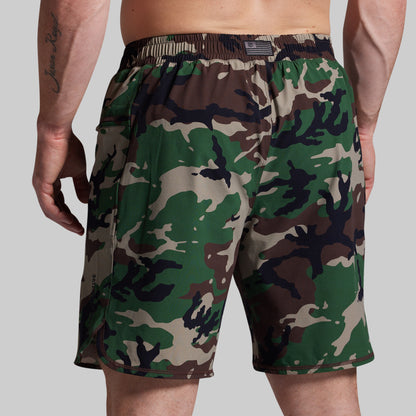 Camouflage shorts worn by a person on a plain background