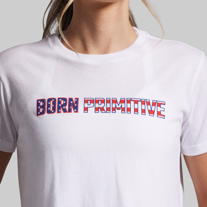 White t-shirt with 'Born Primitive' text in red and blue on a plain background