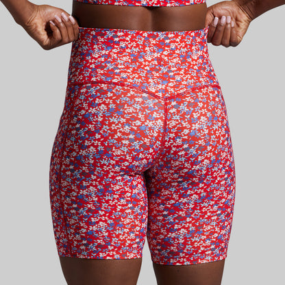 Red floral patterned shorts on a plain background