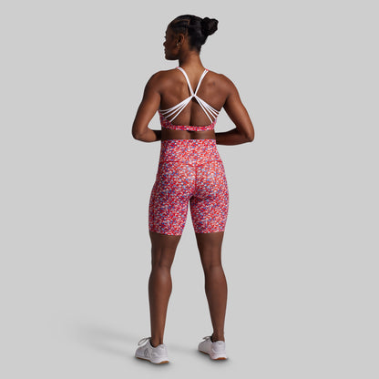 Person wearing a colorful athletic outfit on a plain background