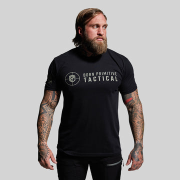 Man wearing a black t-shirt with 'Born Primitive Tactical' logo on a gray background