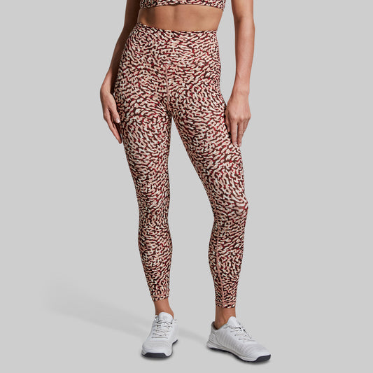 Person wearing leopard print leggings on a gray background