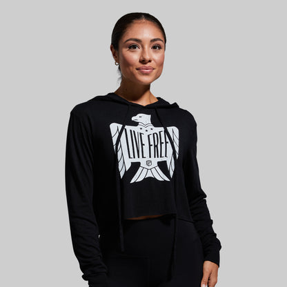 Woman wearing a black hoodie with a white eagle design and 'Live Free' text on a gray background