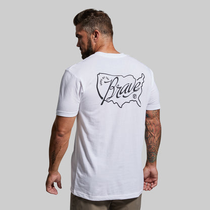 Man wearing a white t-shirt with a logo on the back against a gray background