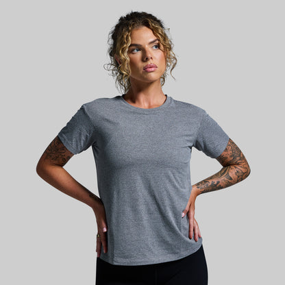 Woman wearing a gray t-shirt against a plain background