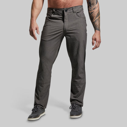 Person wearing gray pants on a plain background
