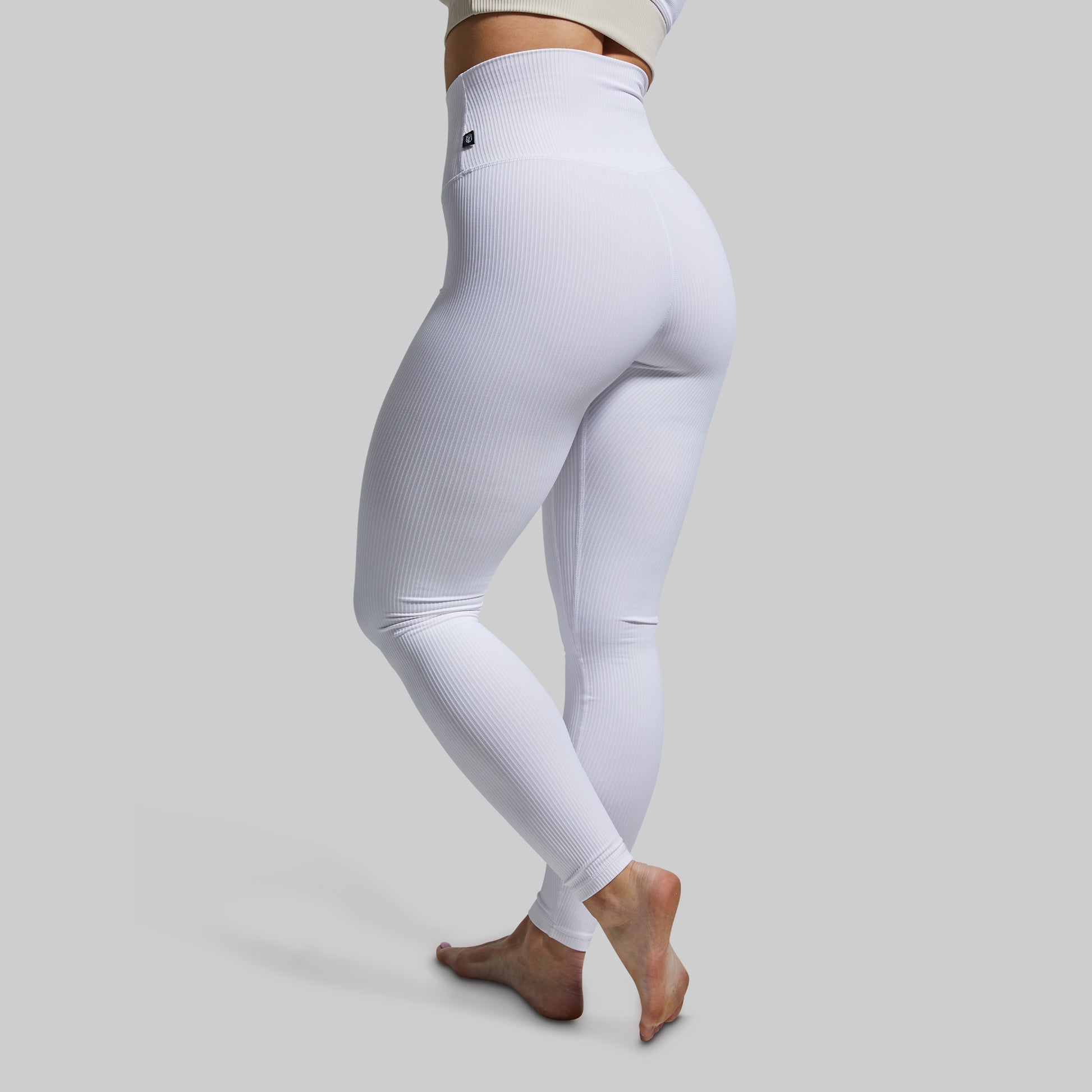 White leggings worn by a person on a light gray background