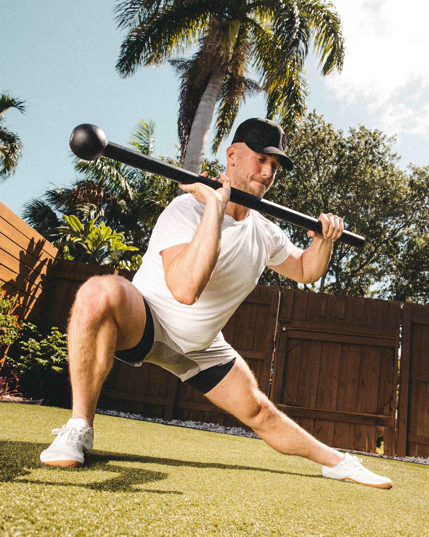 Barefoot athlete doing a mace workout