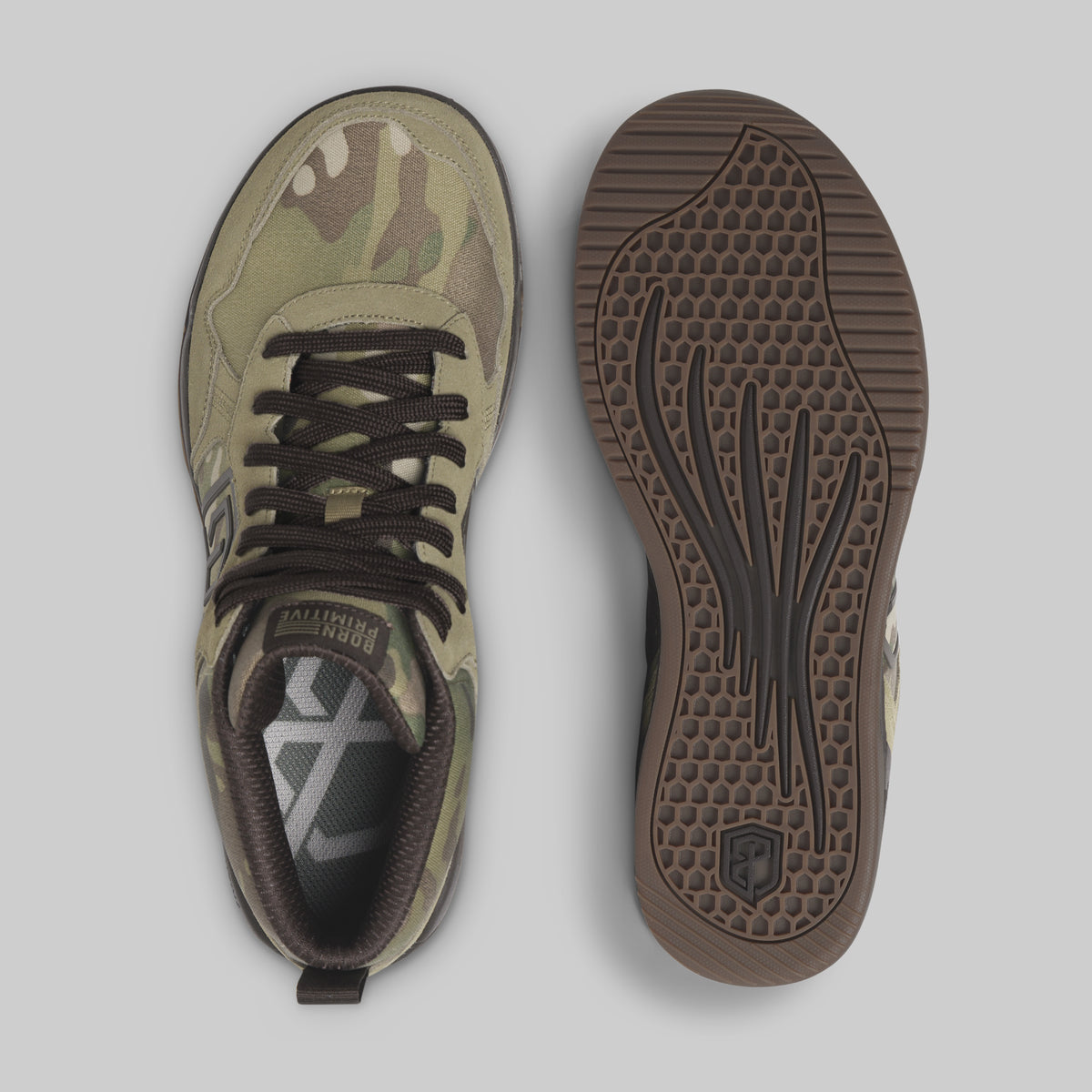 A pair of sneakers shown from the top and side, featuring a camouflage pattern in olive green, tan, and brown, with dark brown laces and a brown textured sole.