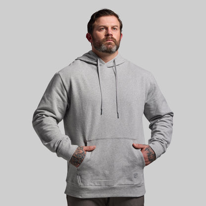 Man wearing a gray hoodie against a plain background