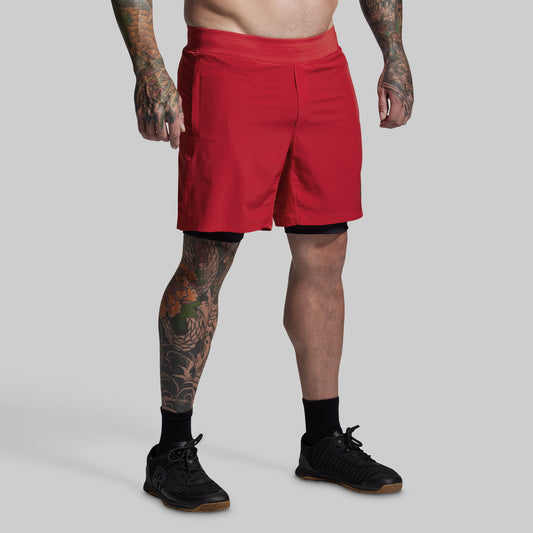 Person wearing red shorts on a gray background