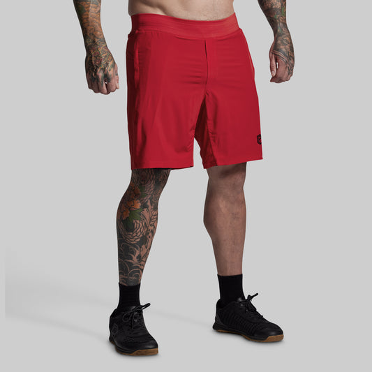 Person wearing red shorts on a gray background