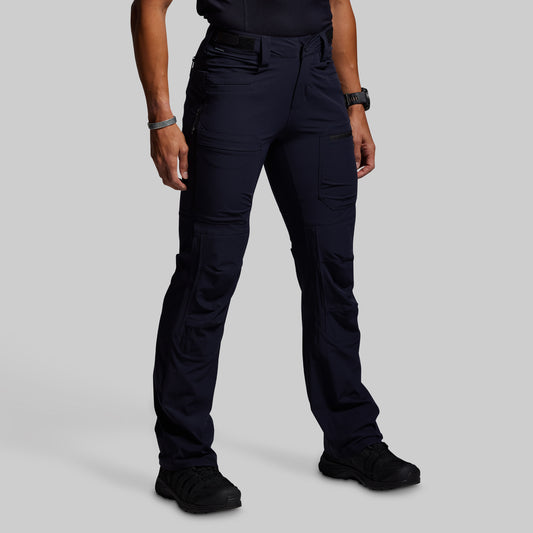 Person wearing blue outdoor pants on a gray background