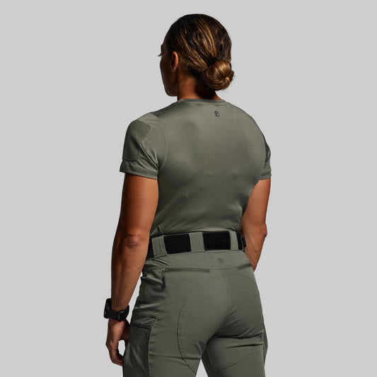Person wearing a green tactical outfit on a plain background