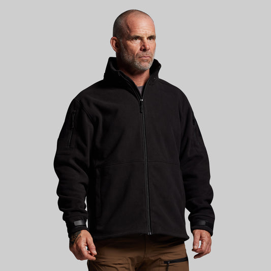 Man wearing a black jacket on a gray background