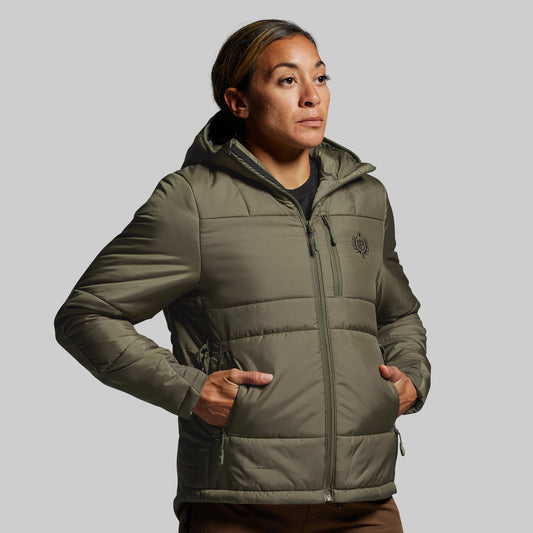 Person wearing a green puffer jacket on a gray background