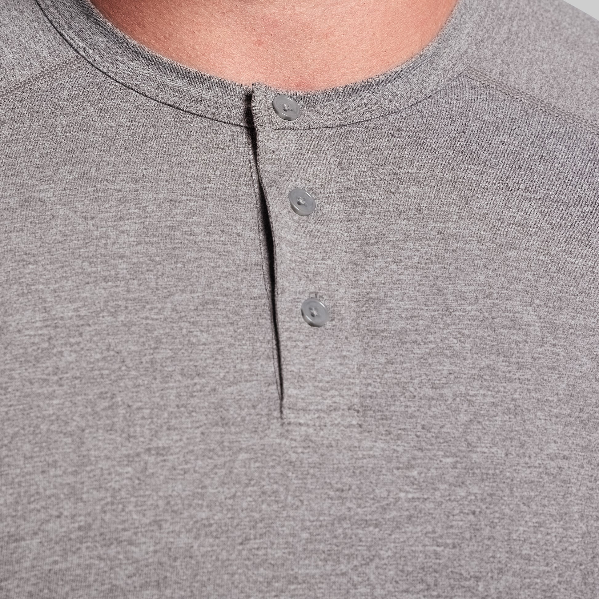 Close-up of a gray henley shirt with button details