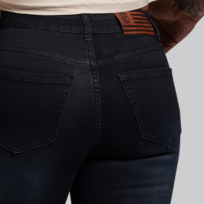 Black jeans with a brand label on a gray background