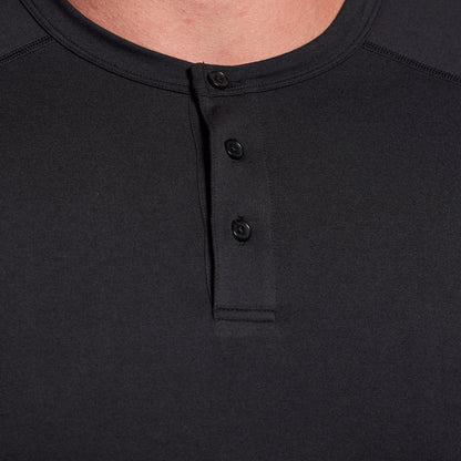 Close-up of a black henley shirt with buttons on a plain background