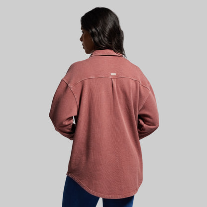 Person wearing a red shirt on a gray background