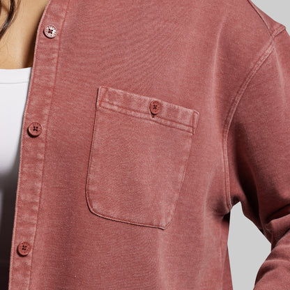 Close-up of a red shirt with a pocket on a plain background