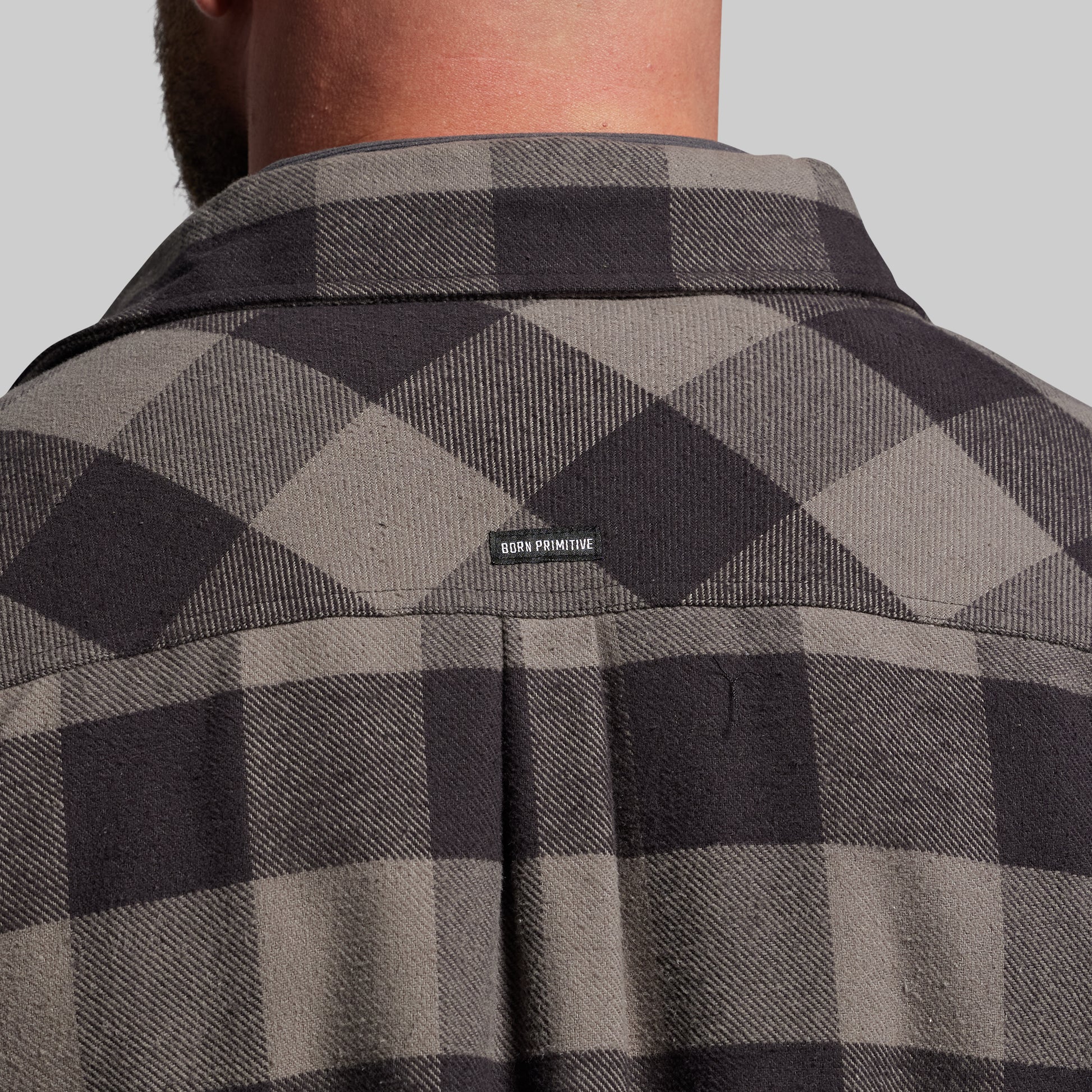 Gray and black checkered jacket with a brand logo on the back.