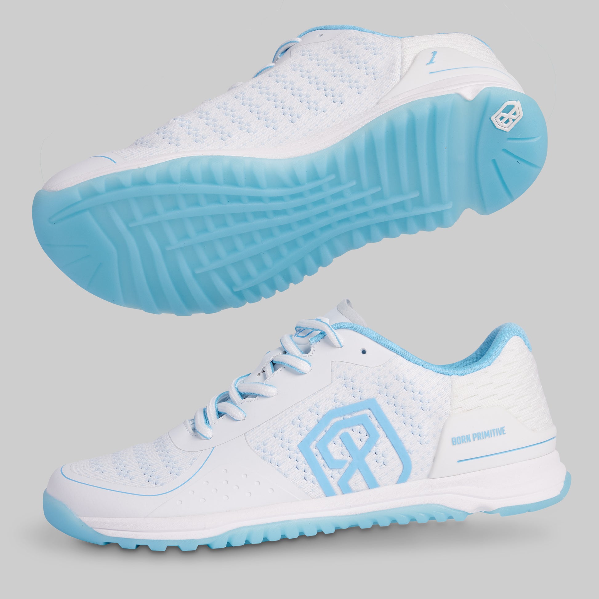 White athletic shoes with blue soles on a gray background